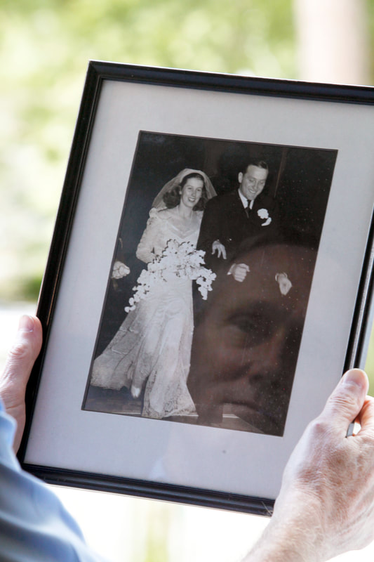 Willy looks upon a cherished photograph of his parents' wedding day